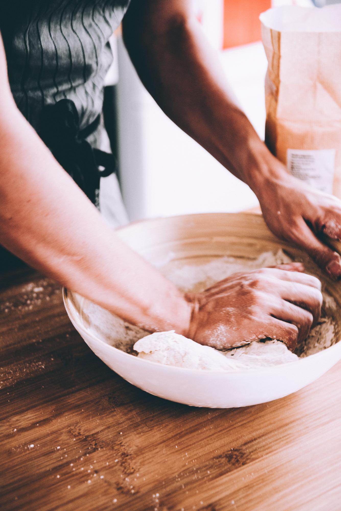 Close-up of hands preparing dough in studio