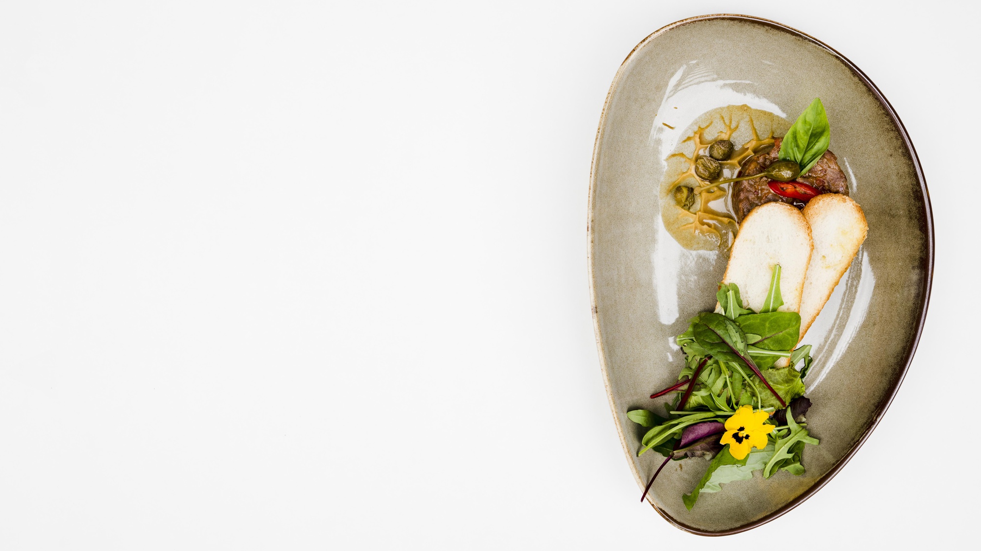 Large editorial shot of plated course on wooden table