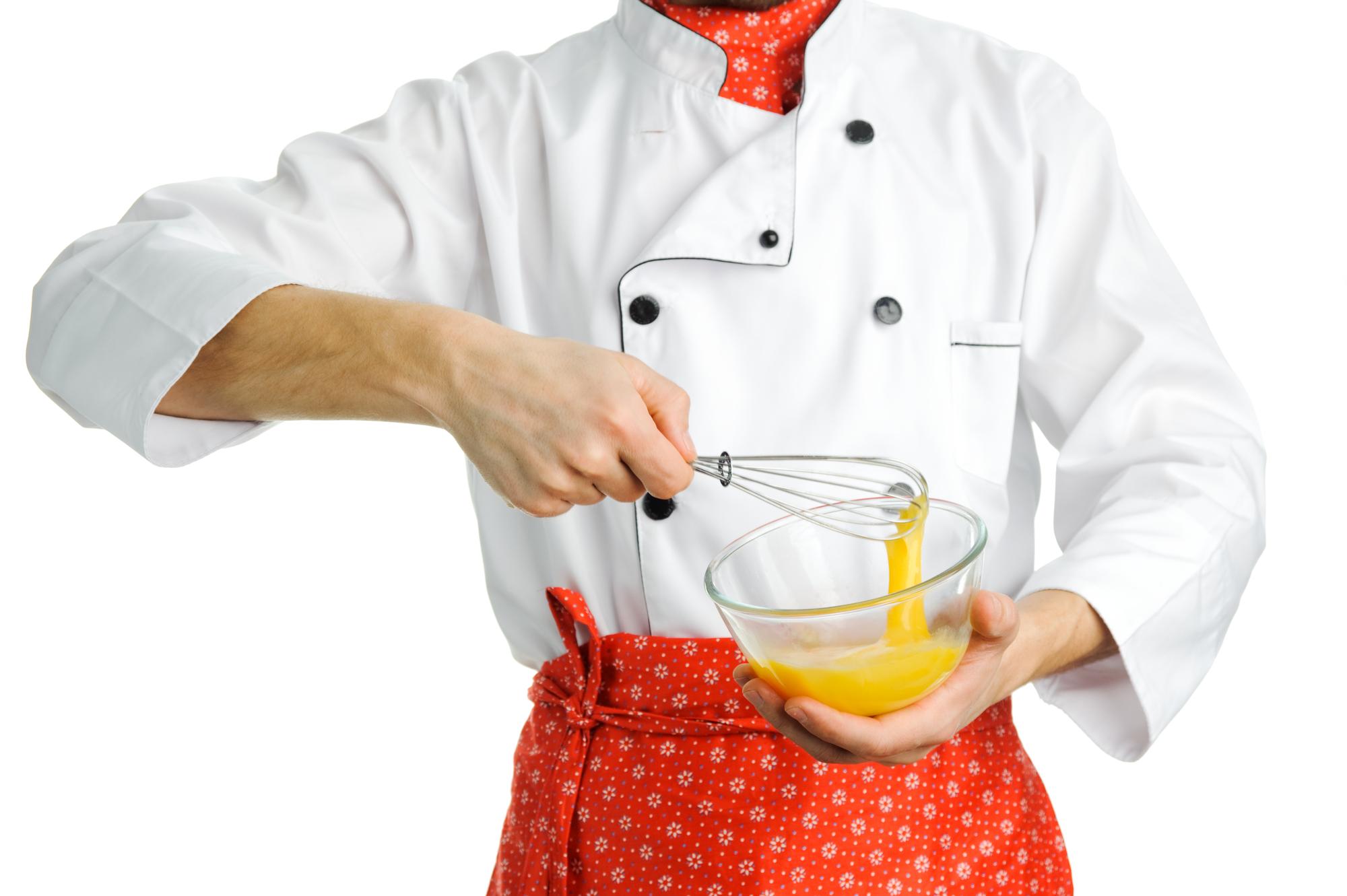 Student finishing sauce at a burner